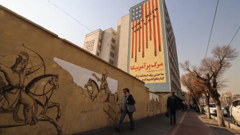 Iranians walk past an anti-US mural on a street in Tehran, on January 6, 2026. (Getty Images)