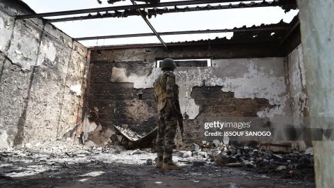 A soldier stands at a damaged house in Bosso military camp on June 17, 2016 following attacks by Boko Haram fighters in the region. Boko Haram on June 9 attacked a military post in Bosso in Niger's Diffa region, killing 26 soldiers. (Photo by ISSOUF SANOGO / AFP) (Photo by ISSOUF SANOGO/AFP via Getty Images)