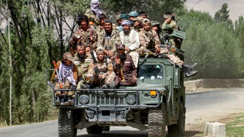 Armed Taliban security personnel sit atop a Humvee armored vehicle as they ride along a street in Badakhshan on September 1, 2024. (Getty Images)