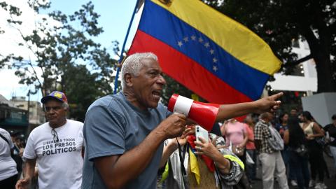 A demonstrator takes part in a protest outside the Melia Caracas Hotel in Caracas, Venezuela, on August 12, 2026. (Getty Images)