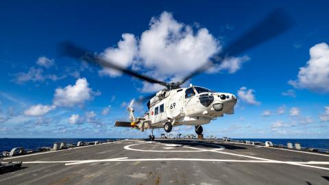 A Japan Maritime Self-Defense Force SH-60K helicopter takes off from the flight deck of the Arleigh Burke-class guided-missile destroyer USS Higgins on June 11, 2024. (US Navy)