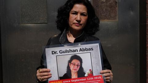 Campaign for Uyghurs Executive Director Rushan Abbas holds a photo of her sister, Gulshan Abbas, in New York on March 22, 2021. (Getty Images)