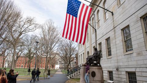 People gather around the John Harvard Statue on the Harvard University campus in Cambridge, Massachusetts, on April 15, 2025. (Getty Images)