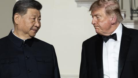 Chinese President Xi Jinping looks to US President Donald Trump as they descend the grand staircase before a state dinner in the East Room of the White House on September 24, 2026, in Washington, DC. (Getty Images)