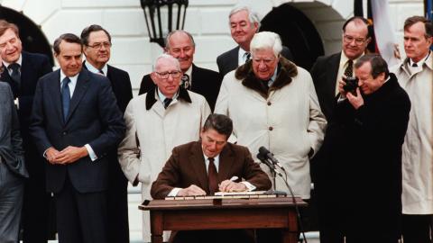 President Ronald Reagan signs the Social Security Act Amendment with Vice President George Bush, Senator Bob Dole, and Congressmen Tip O'Neill and Daniel Moynihan on hand as witnesses on April 20, 1983. (Getty Images)