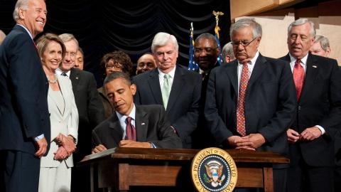 US President Barack Obama signs the Dodd-Frank Wall Street Reform and Consumer Protection Act alongside members of Congress and the administration in Washington, DC, on July 21, 2010. (Getty Images)