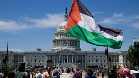 A demonstrator carries a Palestinian flag as people gather near the US Capitol in Washington, DC, on May 16, 2026. (Getty Images)