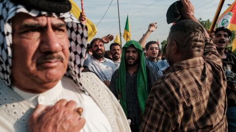 Supporters of the Popular Mobilisation Forces (PMF) chant slogans and wave flags at a rally celebrating the end of the US military presence in Iraq on September 30, 2026, in Baghdad, Iraq. (Getty Images)