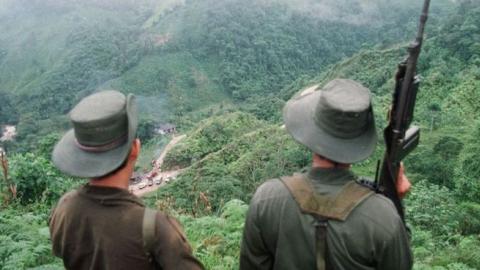 Two armed soldiers belonging to the Revolutionary Armed Forces of Colombia (FARC) monitor the Berlin pass, near Florencia, in the southern Caqueta province of Colombia, March 7, 1998. (PEDRO UGARTE/AFP/Getty Images)