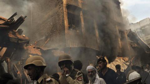 A Pakistani security serviceman is pictured amid bodied and wreckage at the scene of a bomb explosion in Quetta on March 14, 2014. (BANARAS KHAN/AFP/Getty Images)