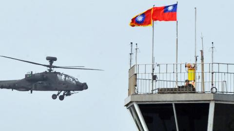 A US-made AH-64E Apache attack helicopter flies during a ceremony in an army airborne special force unit in Tainan, southern Taiwan on December 13, 2013. (Mandy Cheng/AFP/Getty Images)