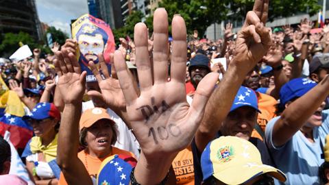 Opposition activists take part in a demonstration against President Nicolas Maduro in Caracas on July 9, 2017 (Juan Barreto/AFP/Getty Images)