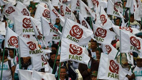 FARC members and supporters wave flags with the new logo of the rebaptized FARC following its disarmament, September 1, 2017 (RAUL ARBOLEDA/AFP/Getty Images)
