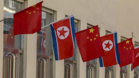 Chinese and North Korean flags outside the Sino-Korea bilateral trade market (Zhang Peng/LightRocket via Getty Images)