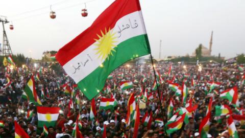 Iraqi Kurds fly Kurdish flags during an event to urge people to vote in the upcoming independence referendum, September 16, 2017 (SAFIN HAMED/AFP/Getty Images)