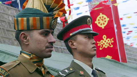 An Indian soldier and his Chinese counterpart at a ceremony marking the re-opening of the China-India border, July 6, 2006 (DESHAKALYAN CHOWDHURY/AFP/Getty Images)