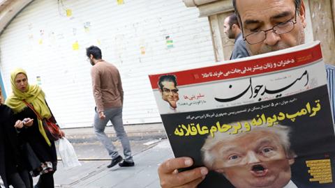 Iranian man reads a newspaper with the headline "Crazy Trump and logical JCPOA," October 14, 2017 