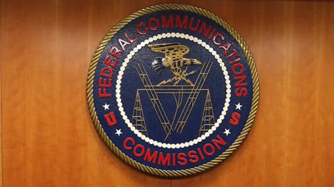 The seal of the Federal Communications Commission hangs behind commissioner Tom Wheeler's chair inside the hearing room at the FCC headquarters February 26, 2015 in Washington, DC. The Commission will vote on Internet rules, grounded in multiple sources o