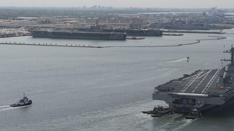 USS Gerald R. Ford (CVN 78) arriving at Naval Station Norfolk in Virginia approaching its berth next to the Nimitz-class aircraft carriers USS Dwight D. Eisenhower (CVN 69) and USS George Washington (CVN 73)