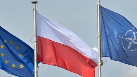 A view of EU, Polish and NATO flags at the Presidential Palace in Warsaw, June 21, 2016 (Artur Widak/NurPhoto via Getty Images)