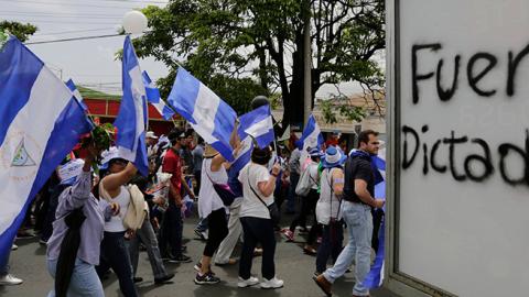 People attend the 'Marcha de las Flores' -in honor of the children killed during protests- in Managua on June 30, 2018 