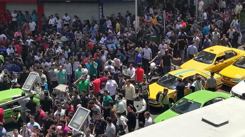 Iranian protesters shout slogans during a demonstration in central Tehran, June 25, 2018 