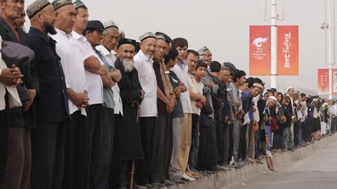 Ethnic Uyghurs forced to attend memorial ceremony for Chinese police officers killed in a terrorist attack in Xinjiantg, August 7, 2008 