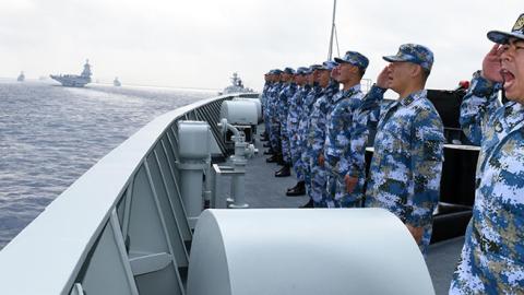 A PLA Navy fleet including the aircraft carrier Liaoning, submarines, vessels and fighter jets take part in a review in the South China Sea.