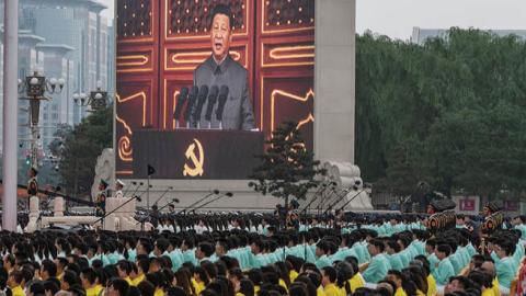 Chinese leader Xi Jinping is seen on a screen as the crowd listens during his speech at a ceremony marking the 100th anniversary of the Communist Party at Tiananmen Square on July 1, 2021 in Beijing, China. (Getty Images)
