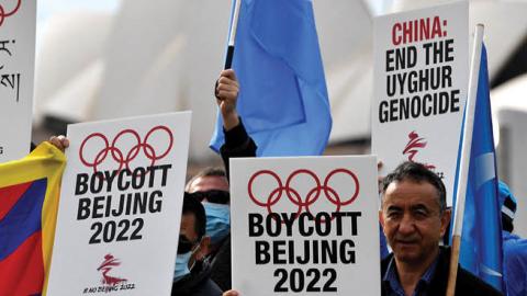 Protesters hold up placards and banners as they attend a demonstration in Sydney on June 23, 2021 to call on the Australian government to boycott the 2022 Beijing Winter Olympics over China's human rights record. (Getty Images)