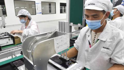 Employees assemble phone components at a Lenovo/Motorola factory in Wuhan, China, on Aug. 20, 2021. (Getty Images)