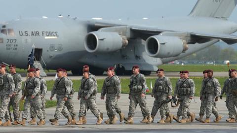 Members of the U.S. Army 173rd Airborne Brigade disembark upon their arrival by plane at a Polish air force base on April 23, 2014, in Swidwin, Poland. (Getty Images)