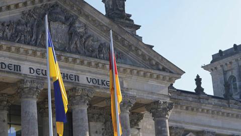 Flags representing the EU, Ukraine, and Germany fly in front of the Reichstag in Berlin, Germany, during a special session of the Bundestag. (Getty Images)
