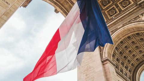 A French flag hangs from the Arc de Triomphe during the 100 Anniversary of the Tomb of the Unknown Soldier on November 11, 2020, in Paris, France. (Getty Images)