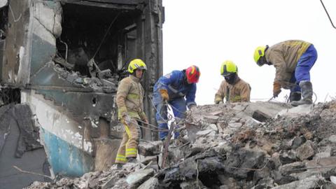 Firefighters remove rubble at a destroyed apartment building on April 10, 2022, in Borodyanka, Ukraine. (Getty Images)