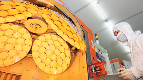 An employee works on the production line of LED epitaxial wafer on March 25, 2022, in Jiangsu Province, China. (Zhao Qirui/VCG via Getty Images)