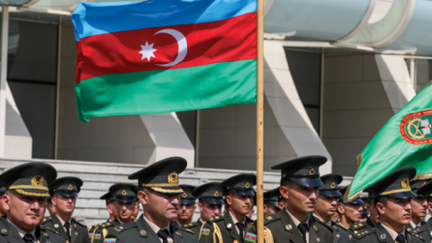 Members of the military stand at attention in front of Heydar Aliyev Palace during the Armed Forces Day celebrations on June 26, 2022 in Baku, Azerbaijan. (Aziz Karimov/Getty Images)