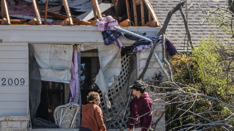 People look at their damaged house after tornados in Round Rock, Texas, on March 22, 2022. (Bo Lee/Xinhua via Getty Images)