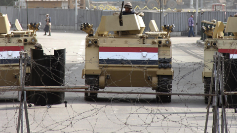 Egyptian soldiers are seen standing guard in military vehicles in Cairo's Tahrir square on January 26, 2014 the day after thousands of demonstrators protested in the square. (AHMED TARANH/AFP/Getty Images) 