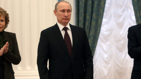 Russia's President Vladimir Putin after signing a law on ratification of a treaty making Crimea part of Russia in the Kremlin in Moscow March 21, 2014, with Valentina Matviyenko (L) and Sergei Naryshkin (R) applauding. (SERGEI CHIRIKOV/AFP/Getty Images)