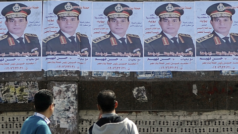 Egyptians look at a row of portraits of Egyptian army chief Abdel Fattah al-Sisi in Alexandria, Egypt (STR/AFP/Getty Images)