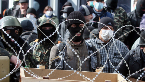 Pro-Russian activists guard a barricade set at the Ukrainian regional Security Service building on the eastern city of Donetsk on April 7, 2014 (Alexander KHUDOTEPLY/AFP/Getty Images)