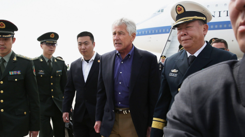 Escorted by Chinese military personnel, U.S. Secretary of Defense Chuck Hagel arrives at Qingdao International Airport April 7, 2014 in Qingdao, China. (Alex Wong/Getty Images)