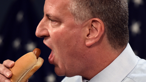 New York City Mayor Bill de Blasio bites a hot dog on July 3, 2014 at City Hall in New York. (DON EMMERT/AFP/Getty Images)
