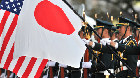 Japanese Ground Self Defense Force honor guards hold national flags for visiting US Army General Martin E. Dempsey at the Defence Ministry in Tokyo on October 28, 2011. (KAZUHIRO NOGI/AFP/Getty Images)