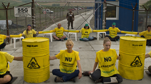 Greenpeace activists wave placards saying 'No fracking' and block the entrance of Chevron's shale gas exploring site in Pungesti village on July 7, 2014. (DANIEL MIHAILESCU/AFP/Getty Images)