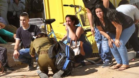 Israeli residents and relatives take cover from a rocket attack from Palestinian militants from the Gaza Strip in Netivot on July 29, 2014. (GIL COHEN MAGEN/AFP/Getty Images)