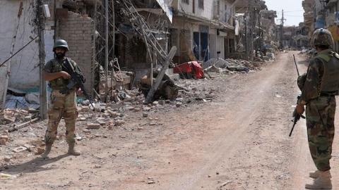 Pakistani soldiers patrol through a destroyed bazaar during a military operation against Taliban militants in Miranshah, North Waziristan, July 9, 2014. (AAMIR QURESHI/AFP/Getty Images)