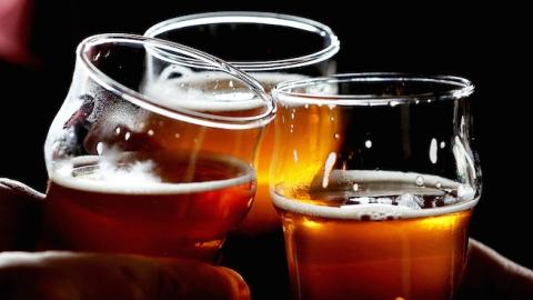 Russian River Brewing Company customers clink their glasses on February 7, 2014 in Santa Rosa, California. (Justin Sullivan/Getty Images)