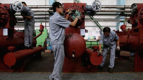 Chinese workers check compressors at Dalian Bingshan Group Co., Ltd. on September 10, 2013 in Dalian of Liaoning Province, China. (Feng Li/Getty Images)